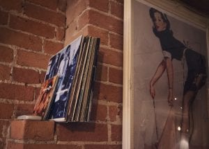 A close up image of a pinup girl and a collection of records