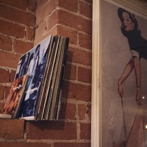 A close up image of a pinup girl and a collection of records